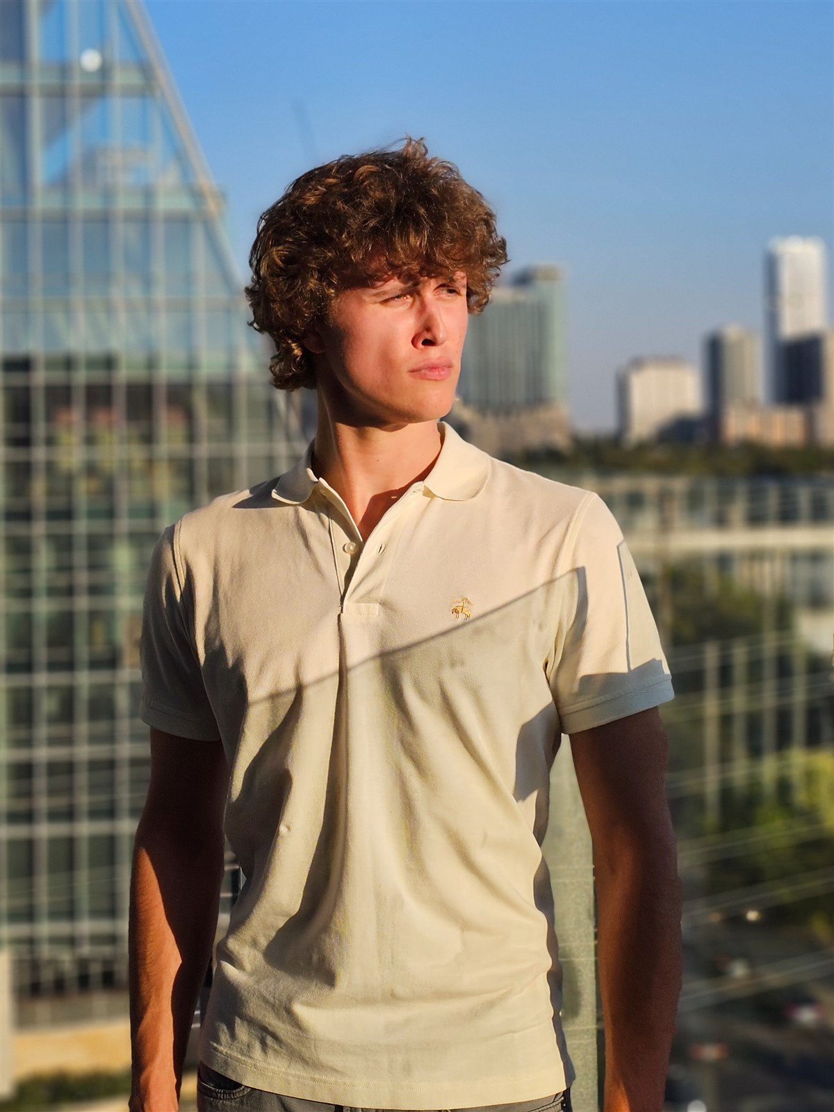 Christopher Voelkel outdoors in Austin with the city skyline behind him.